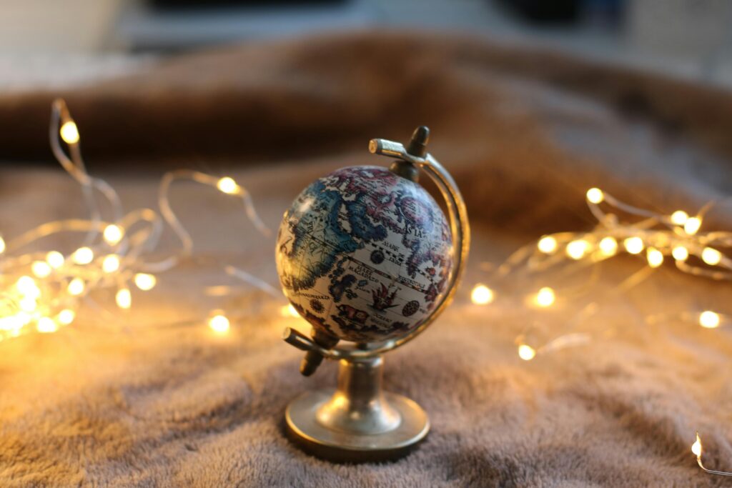 pexels-photo-1563005-1563005 An artistic display of a miniature globe surrounded by glowing string lights.